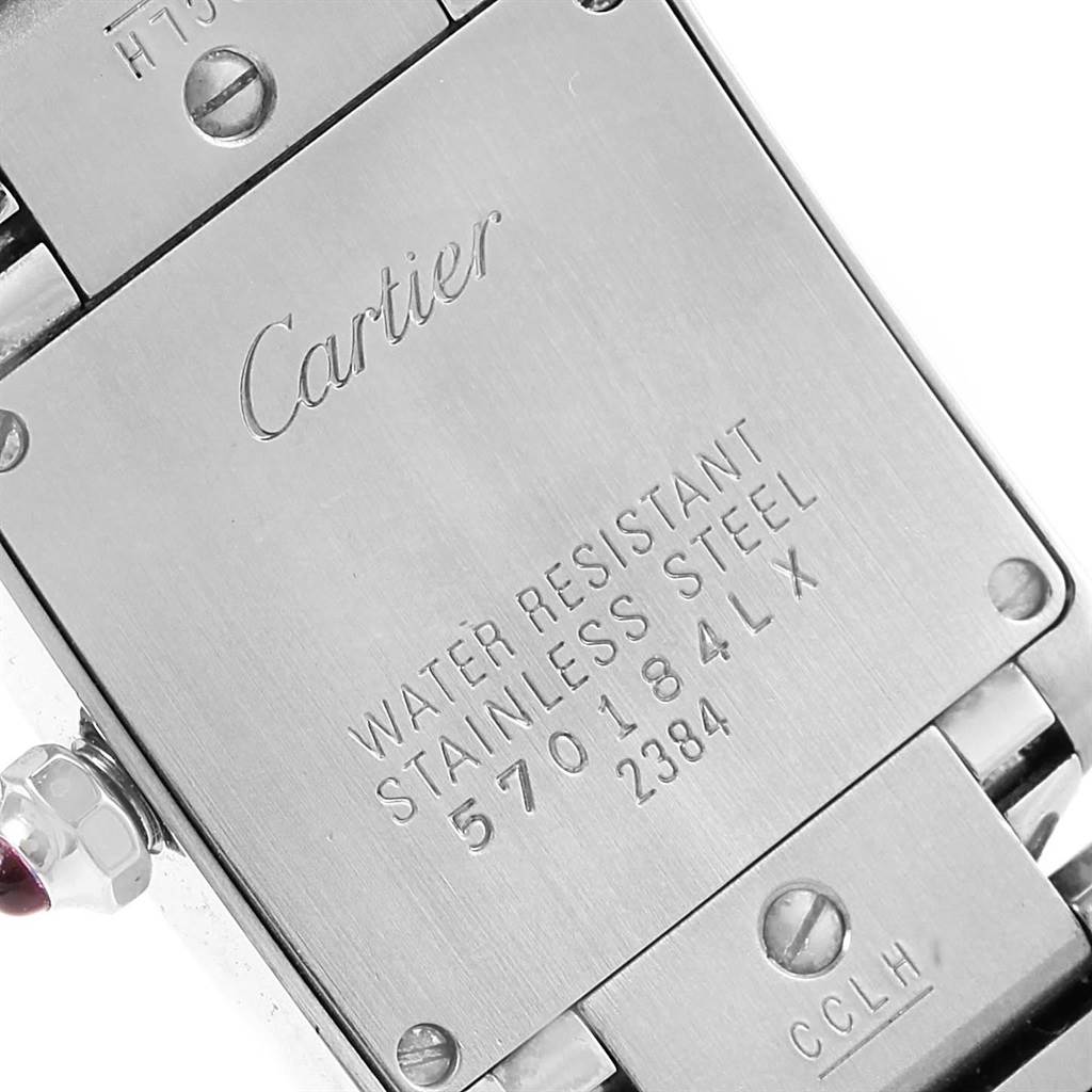 Close-up of the back of a Cartier Tank Francaise W51031Q3 Women's Stainless Steel Silver Dial W51031Q3 Women's Stainless Steel Silver Dial watch showing the engraved text and stainless steel surface.