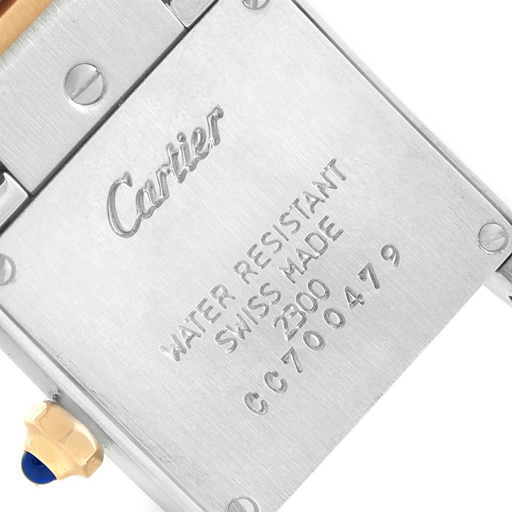 This image shows the back of a Cartier Tank Française watch, displaying the brand, model, and other inscriptions.