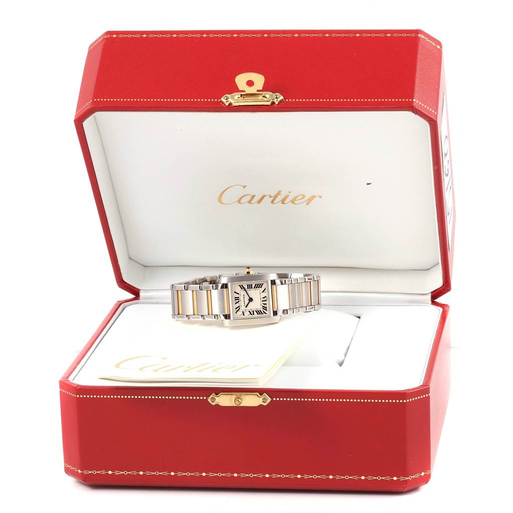 The Cartier Tank Française watch is shown from the front angle inside its red Cartier box.