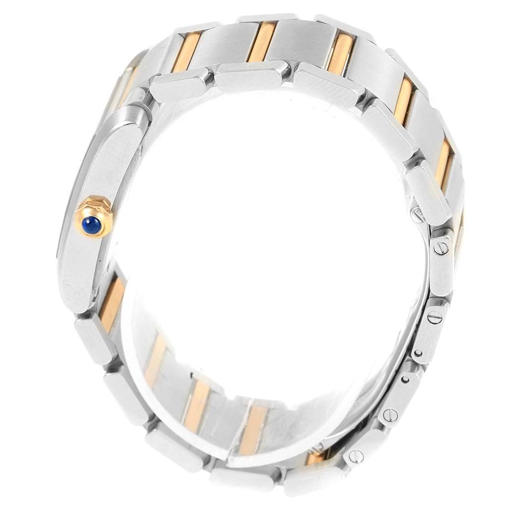 The image shows a side view of the Cartier Tank Francaise W51012Q4 Women's Steel and Gold (two tone) Silver Dial W51012Q4 Women's Steel and Gold (two tone) Silver Dial watch, highlighting its metal bracelet and crown with a blue cabochon.