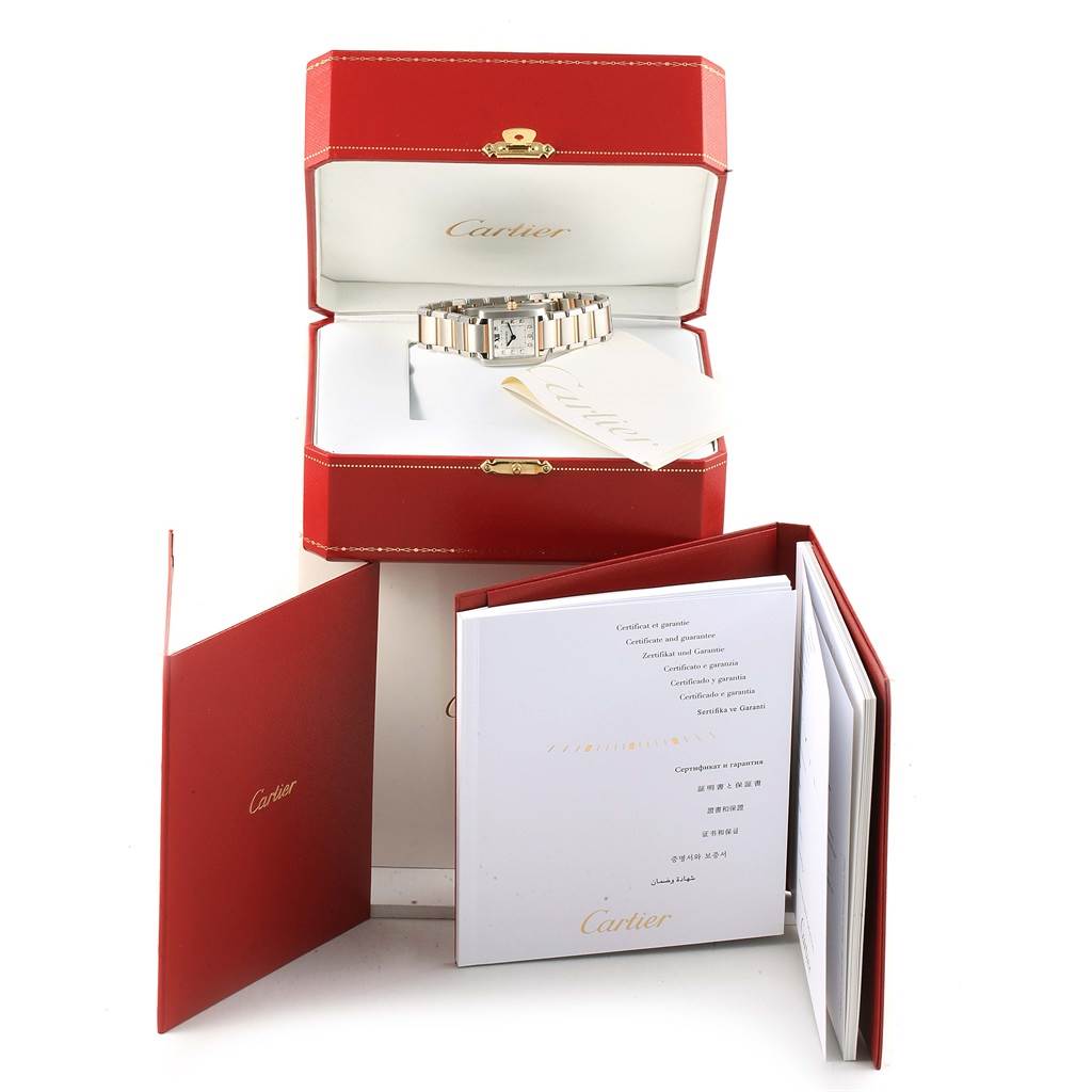 The image shows a Cartier Tank Francaise WE110004 Women's Steel and Gold (two tone) Silver Dial WE110004 Women's Steel and Gold (two tone) Silver Dial watch inside its open red box, accompanied by booklets and documents.