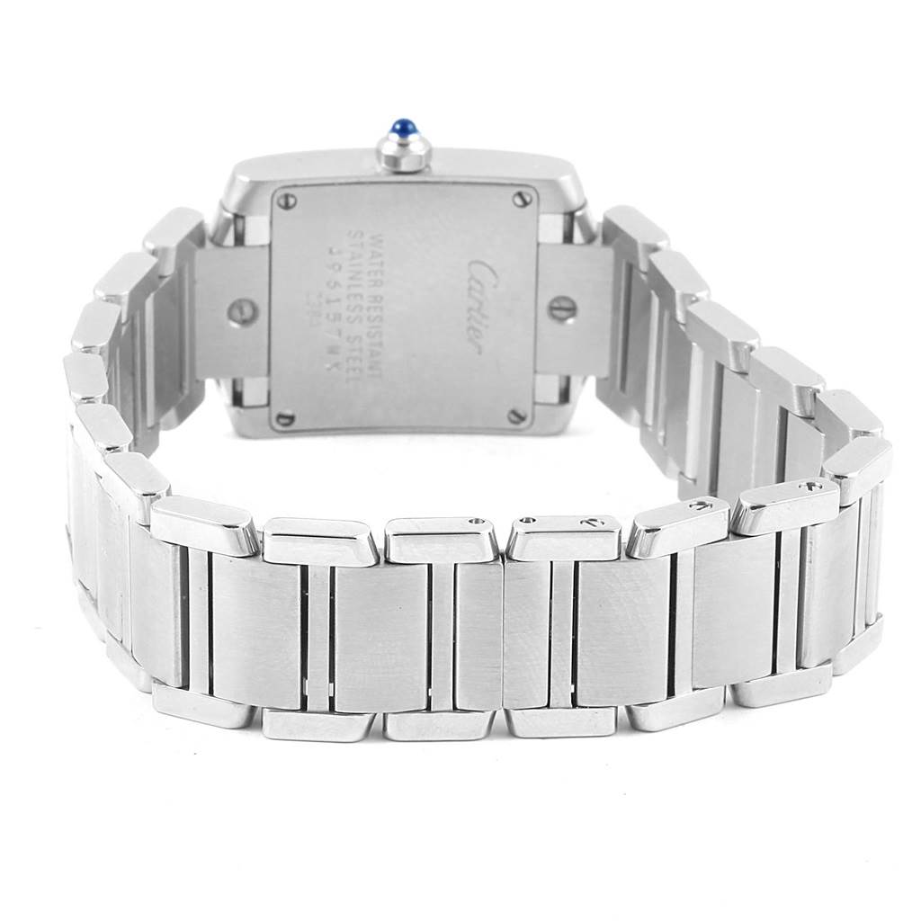 The image shows the back side of a Tank Francaise model by Cartier, highlighting the stainless steel case and bracelet.