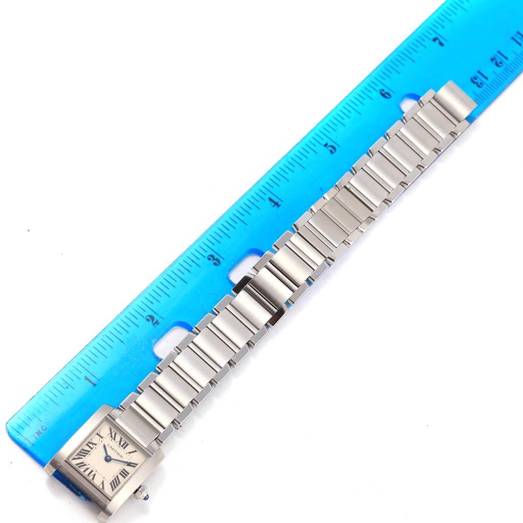 The Cartier Tank Francaise W51008Q3 Women's Stainless Steel Silver Dial W51008Q3 Women's Stainless Steel Silver Dial watch is shown from a top-down angle alongside a ruler for scale.