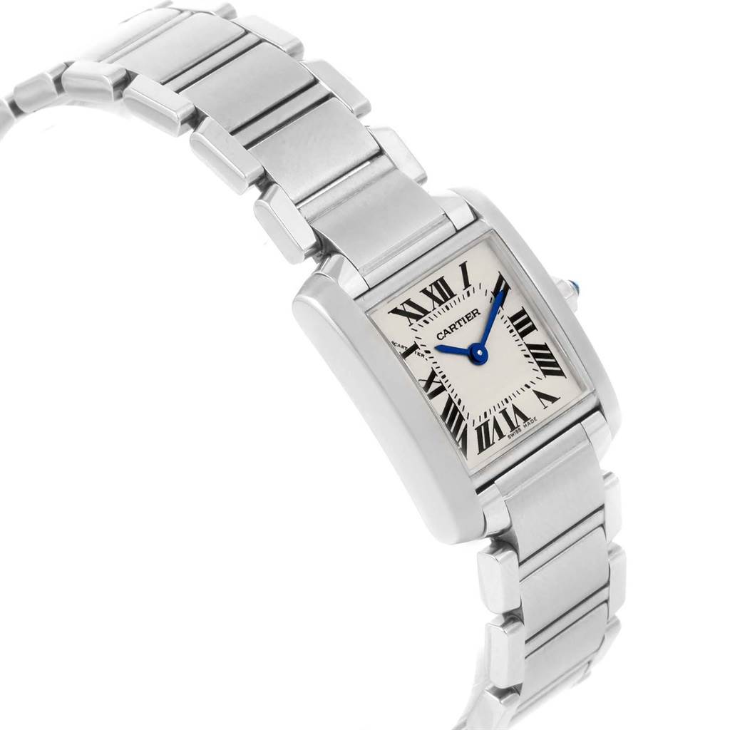 The image shows a Cartier Tank Française watch from a high angle, featuring its silver bracelet and rectangular face with Roman numerals.