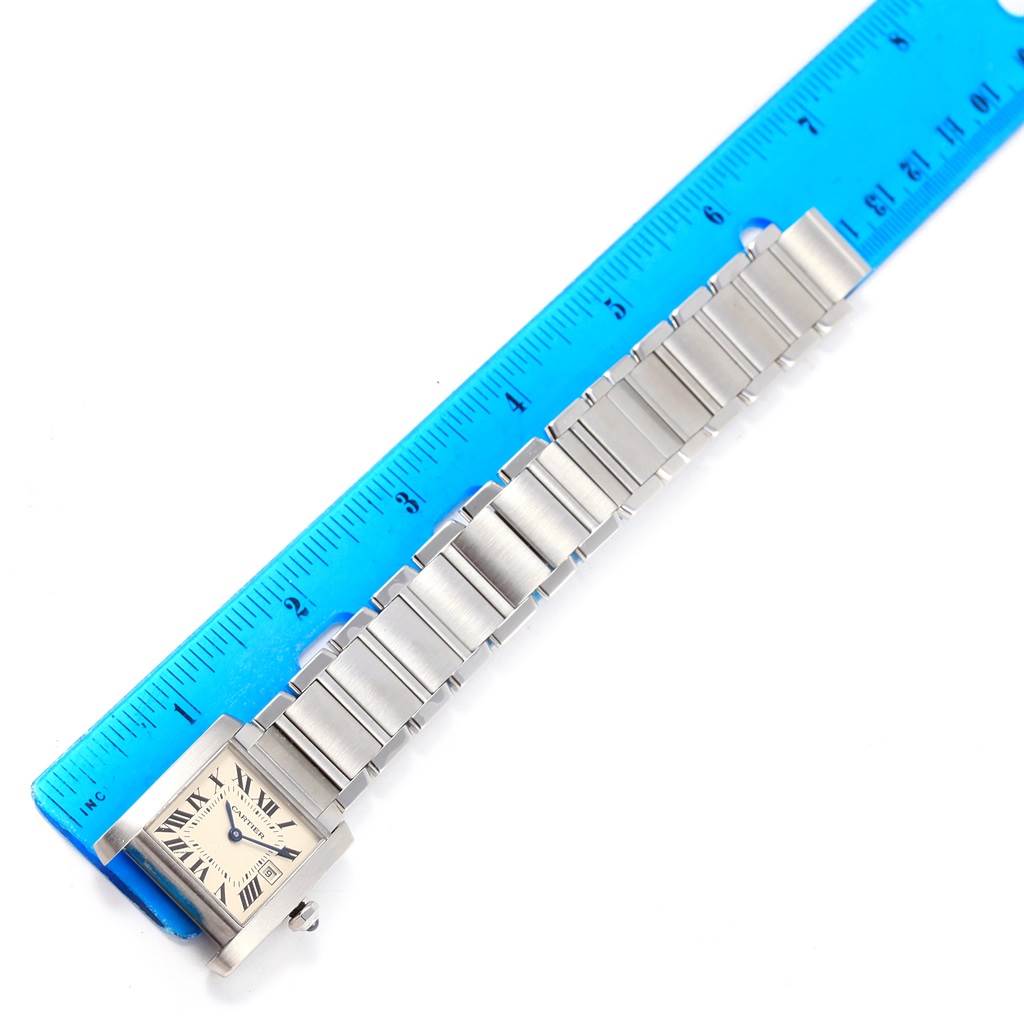 The image shows a Cartier Tank Francaise W51011Q3 Women's Stainless Steel Silver Dial W51011Q3 Women's Stainless Steel Silver Dial watch laid flat next to a blue ruler, displaying the face and bracelet at a top-down angle.