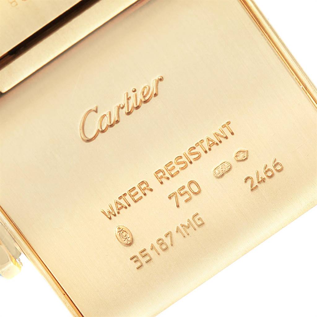 This image shows the back casing of a Cartier Tank Francaise W50014N2 Women's Yellow Gold Silver Dial W50014N2 Women's Yellow Gold Silver Dial watch, highlighting its engraving and hallmark details.