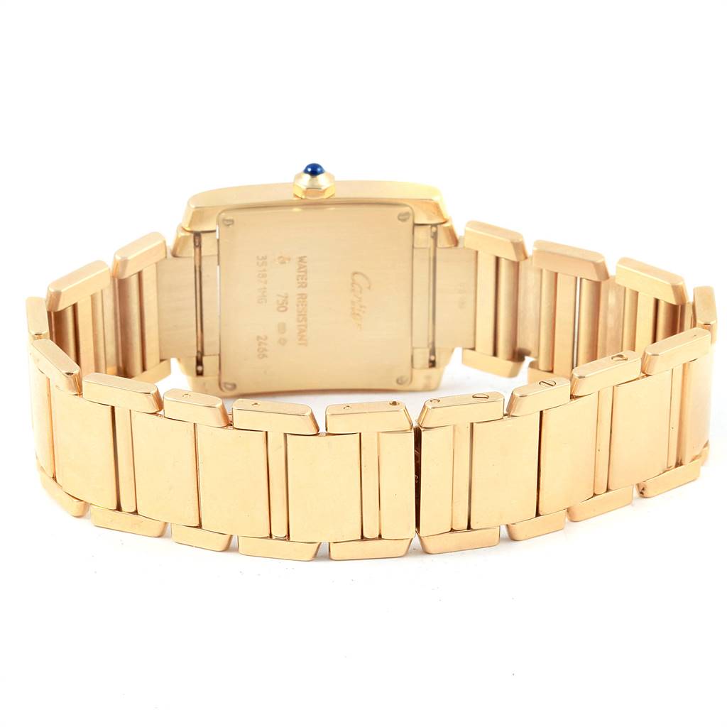The image shows the back view of the gold Cartier Tank Française watch, with the bracelet and caseback visible.