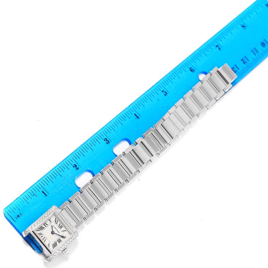 The image shows the Cartier Tank Francaise WE1002S3 Women's White Gold Silver Dial WE1002S3 Women's White Gold Silver Dial watch laid flat and measured with a blue ruler.