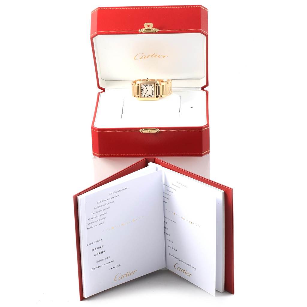 The image shows the Cartier Tank Française watch at a front angle in an open red box with documentation placed in front.