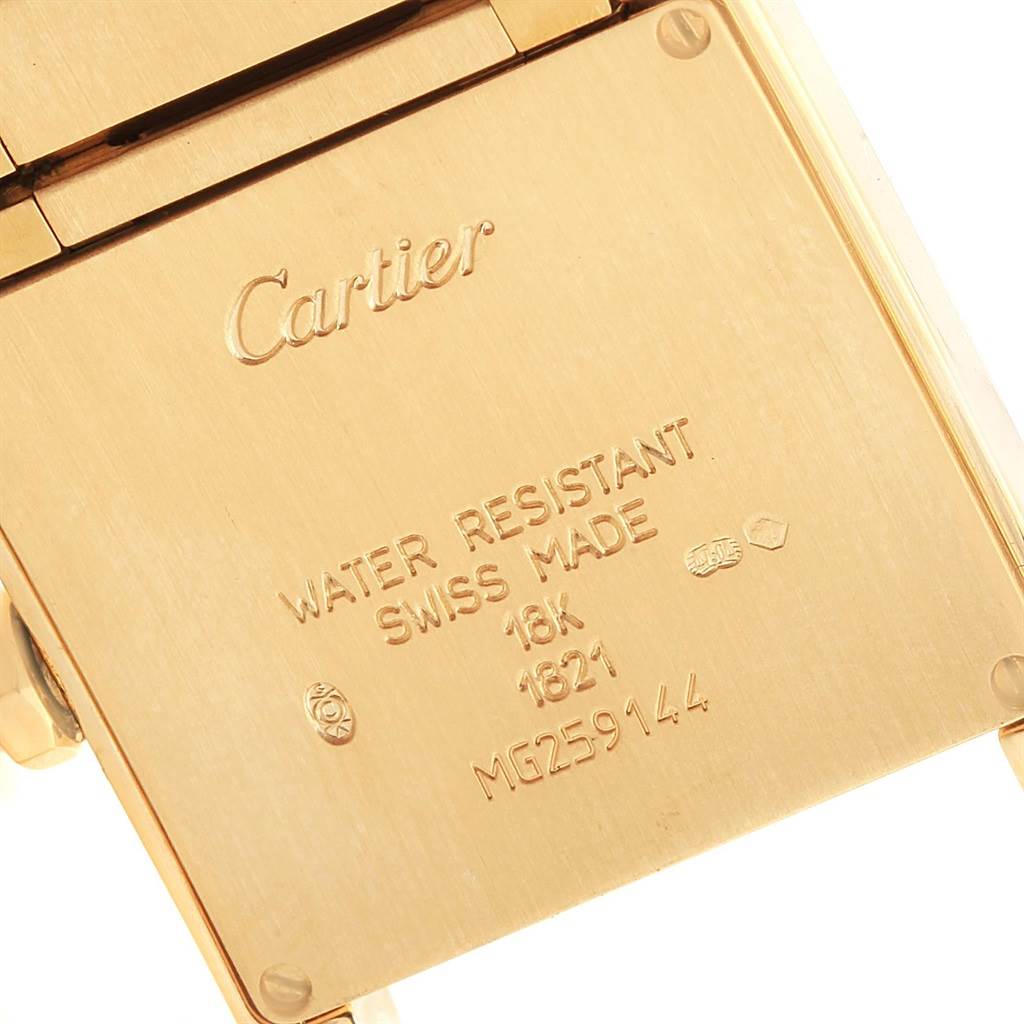 This image shows the back case of a Cartier Tank Francaise W50003N2 Women's Yellow Gold Silver Dial W50003N2 Women's Yellow Gold Silver Dial watch, highlighting its engraving and hinge.