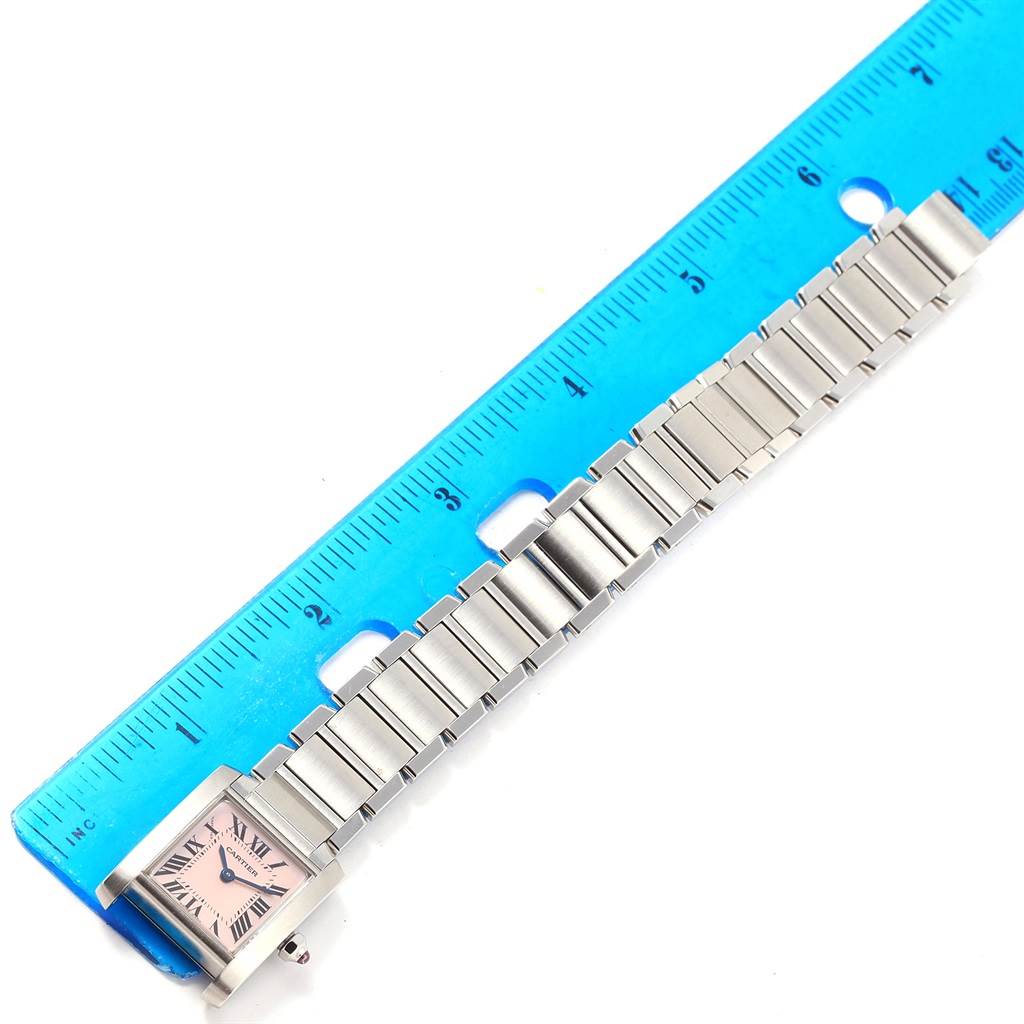 The image shows a Cartier Tank Francaise W51028Q3 Women's Stainless Steel Mother of Pearl Dial W51028Q3 Women's Stainless Steel Mother of Pearl Dial watch laid flat next to a blue ruler for measurement.