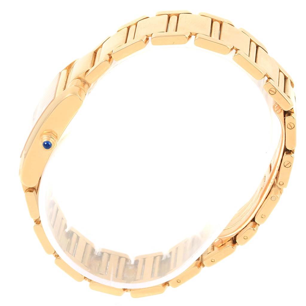 The image shows a Cartier Tank Francaise W50002N2 Women's Yellow Gold Silver Dial W50002N2 Women's Yellow Gold Silver Dial watch from a side angle, highlighting the gold bracelet and crown with a blue cabochon.