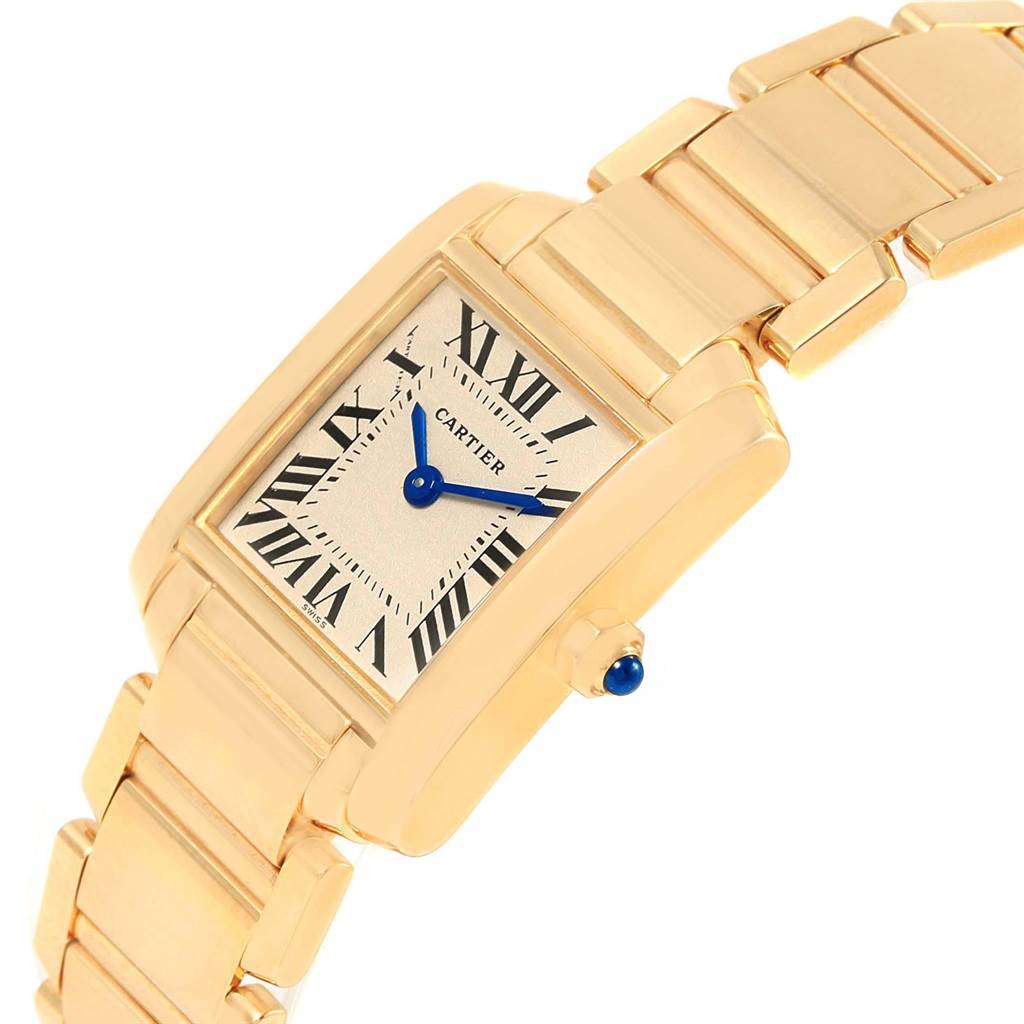 This image shows a Cartier Tank Francaise W50002N2 Women's Yellow Gold Silver Dial W50002N2 Women's Yellow Gold Silver Dial watch from a front angle, highlighting the face, bracelet, and crown with a blue cabochon.