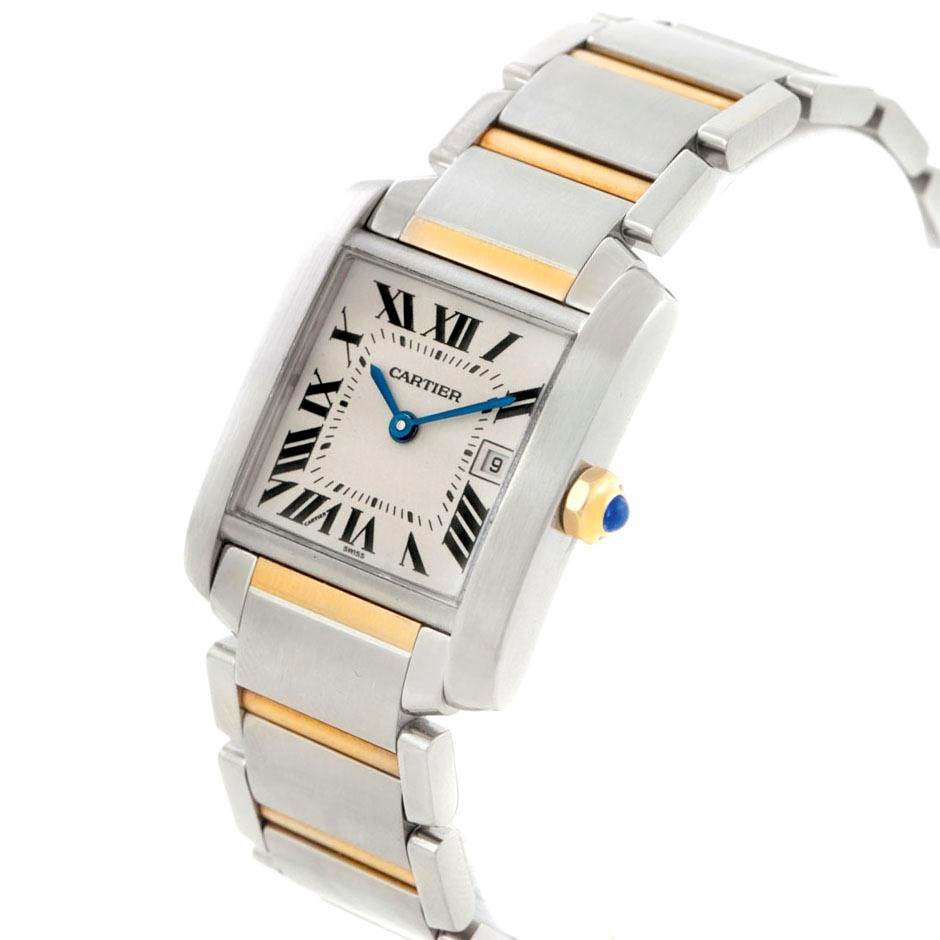 The Cartier Tank Francaise W51012Q4 Women's Steel and Gold (two tone) Silver Dial W51012Q4 Women's Steel and Gold (two tone) Silver Dial watch is shown at an angle highlighting its face, bracelet, and crown with a blue cabochon.