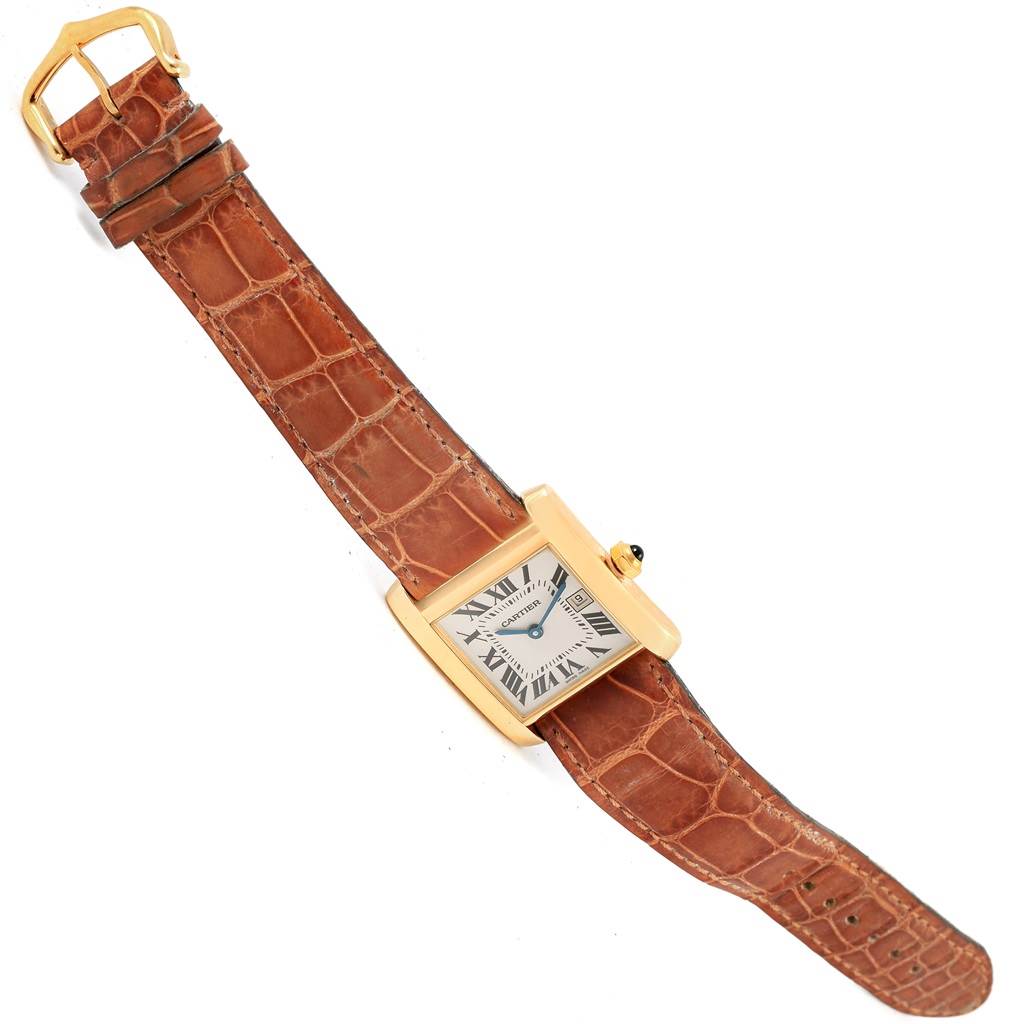 This image shows the Cartier Tank Francaise W50014N2 Women's Yellow Gold Silver Dial W50014N2 Women's Yellow Gold Silver Dial watch at a slight right angle, highlighting its brown leather strap and gold rectangular case.