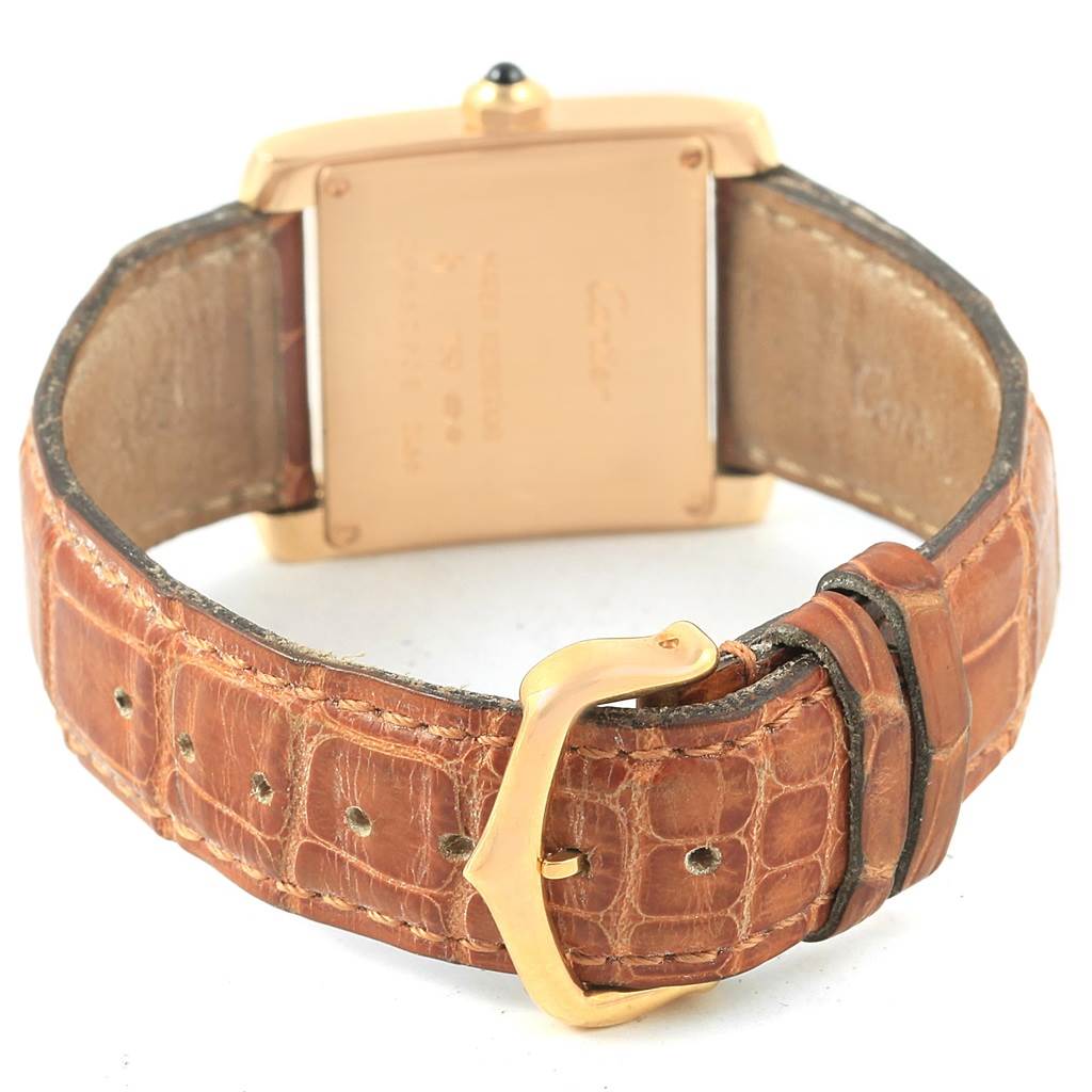 The image shows the back of the Cartier Tank Francaise W50014N2 Women's Yellow Gold Silver Dial W50014N2 Women's Yellow Gold Silver Dial watch, featuring the caseback and leather strap with a gold buckle.