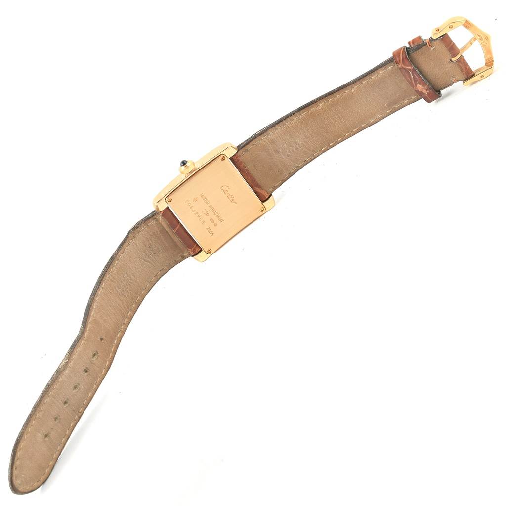 The image shows the backside of a Cartier Tank Française watch, including the case, leather strap, and buckle.