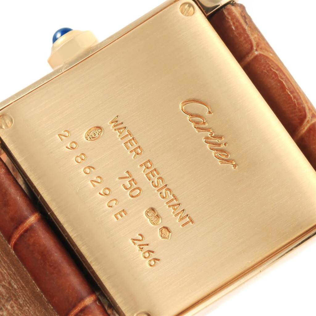 The image displays the back of the Cartier Tank Française watch, showcasing the brand name, model, and water resistance details.