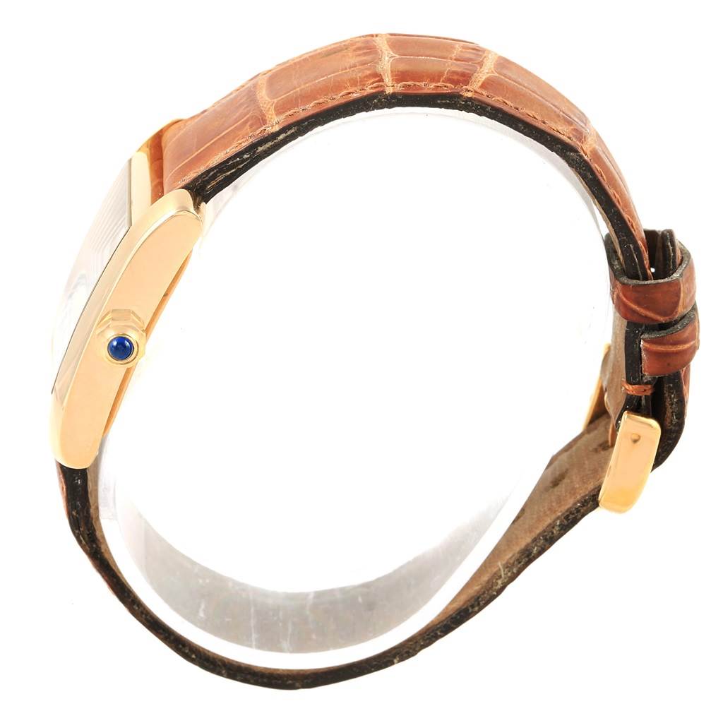 The image shows a side view of a Cartier Tank Francaise W50014N2 Women's Yellow Gold Silver Dial W50014N2 Women's Yellow Gold Silver Dial watch, highlighting its crown and brown leather strap.