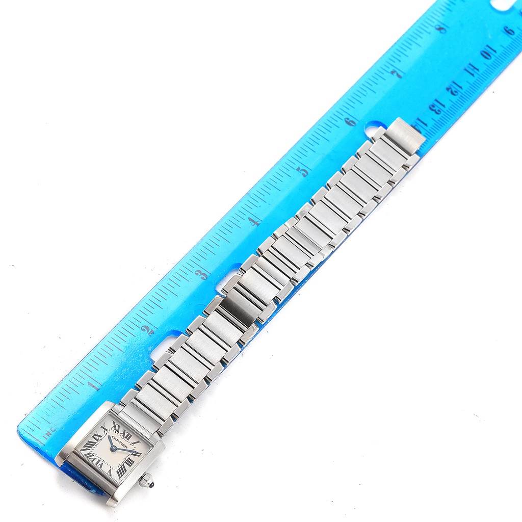 The image shows a flat-lay view of a Cartier Tank Francaise W51008Q3 Women's Stainless Steel Silver Dial W51008Q3 Women's Stainless Steel Silver Dial watch, placed next to a blue ruler for size reference.