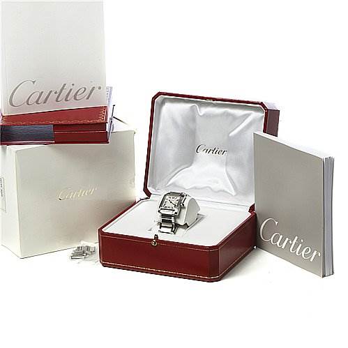 The image shows a Cartier Tank Francaise W51011Q3 Women's Stainless Steel Silver Dial W51011Q3 Women's Stainless Steel Silver Dial watch in its open red box, with additional packaging and booklets around it.