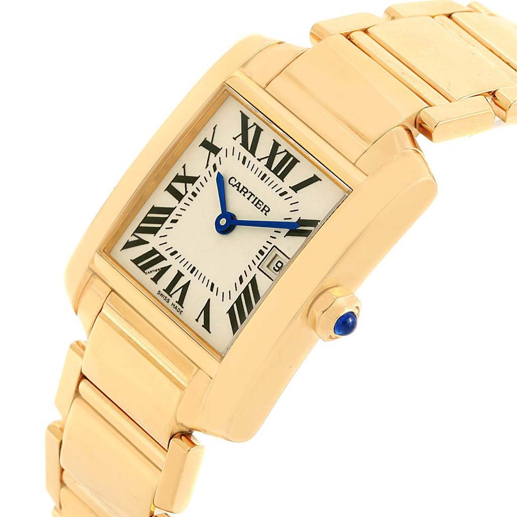 This image shows a Cartier Tank Francaise W50014N2 Women's Yellow Gold Silver Dial W50014N2 Women's Yellow Gold Silver Dial watch at a slightly tilted angle, highlighting the dial, bracelet, and crown with a blue cabochon.