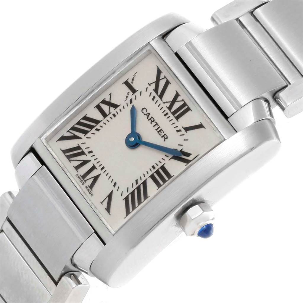 The image shows a close-up of the Cartier Tank Française watch from a diagonal angle, highlighting the dial, crown, and part of the bracelet.