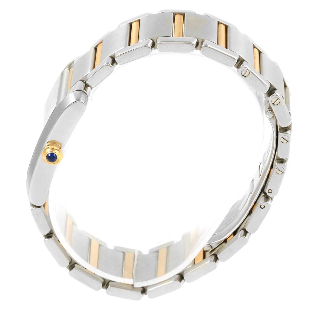 The image shows a side view of the Cartier Tank Francaise W2TA0003 Women's Steel and Gold (two tone) Silver Dial W2TA0003 Women's Steel and Gold (two tone) Silver Dial watch, highlighting the bracelet and crown with a blue cabochon.