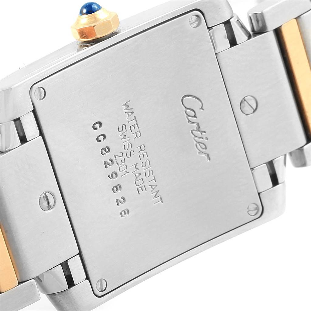 The image shows the back of a Cartier Tank Francaise W2TA0003 Women's Steel and Gold (two tone) Silver Dial W2TA0003 Women's Steel and Gold (two tone) Silver Dial watch, highlighting its case back and part of the bracelet.