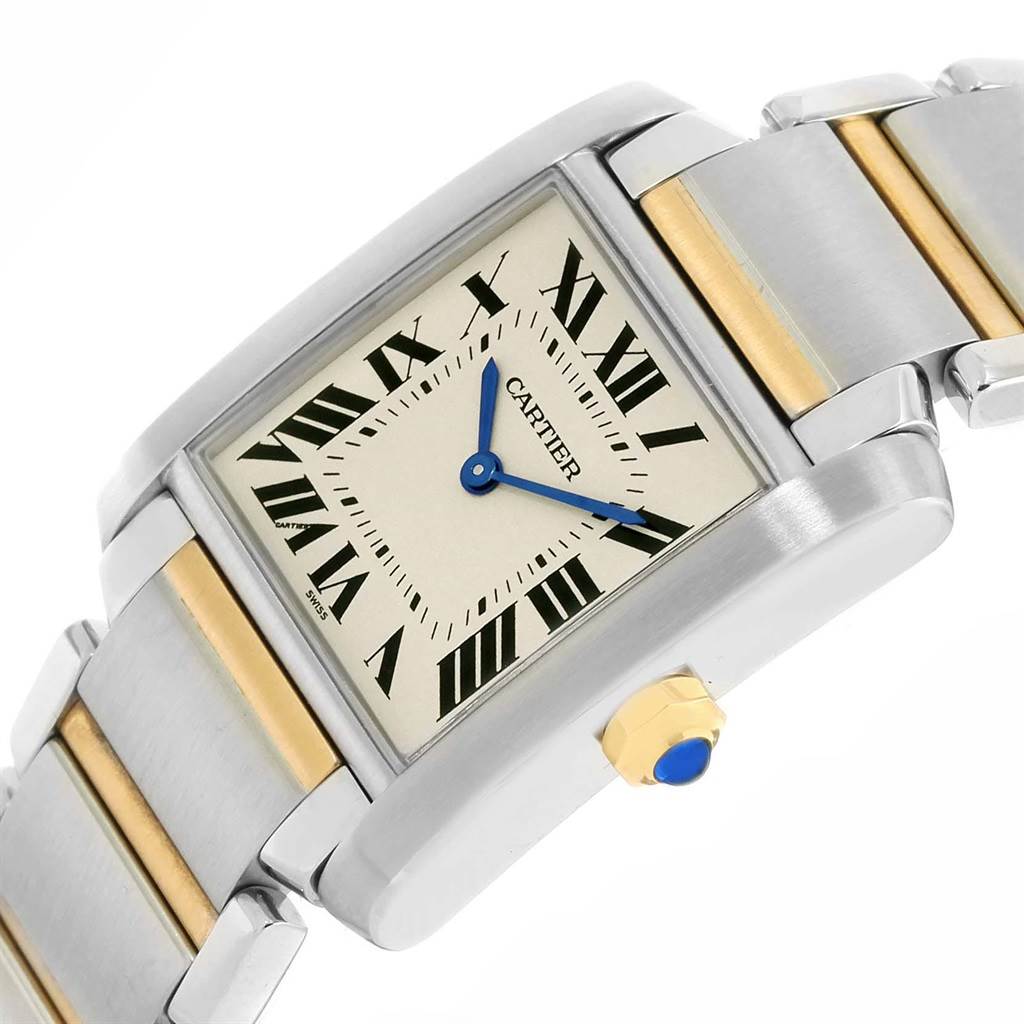 The image shows a Cartier Tank Française watch at an angled view, highlighting its dial, blue hands, and two-tone bracelet.
