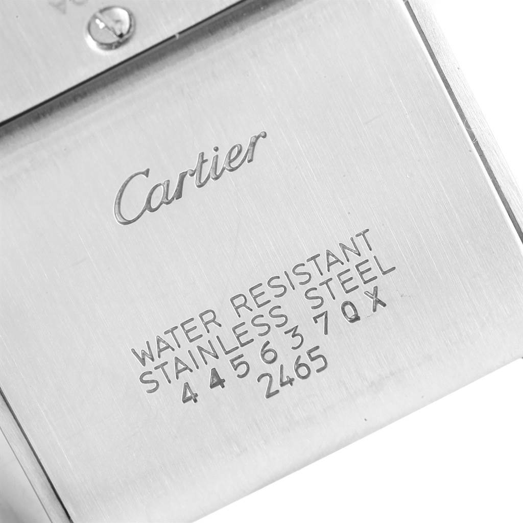 The image shows the back of the Cartier Tank Francaise W51011Q3 Women's Stainless Steel Silver Dial W51011Q3 Women's Stainless Steel Silver Dial watch, featuring engraved details and brand markings.
