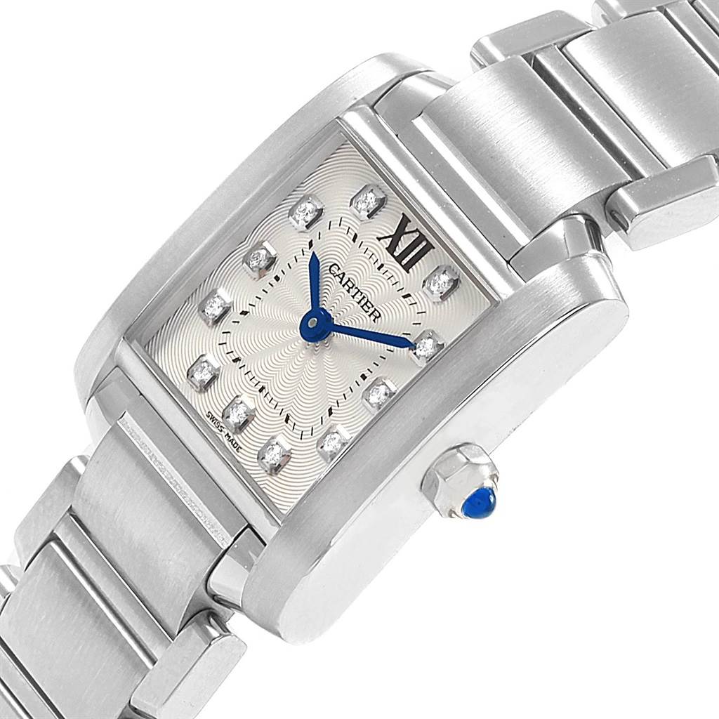 The image shows a close-up of the Cartier Tank Française watch, highlighting its rectangular face, blue hands, and metal bracelet.