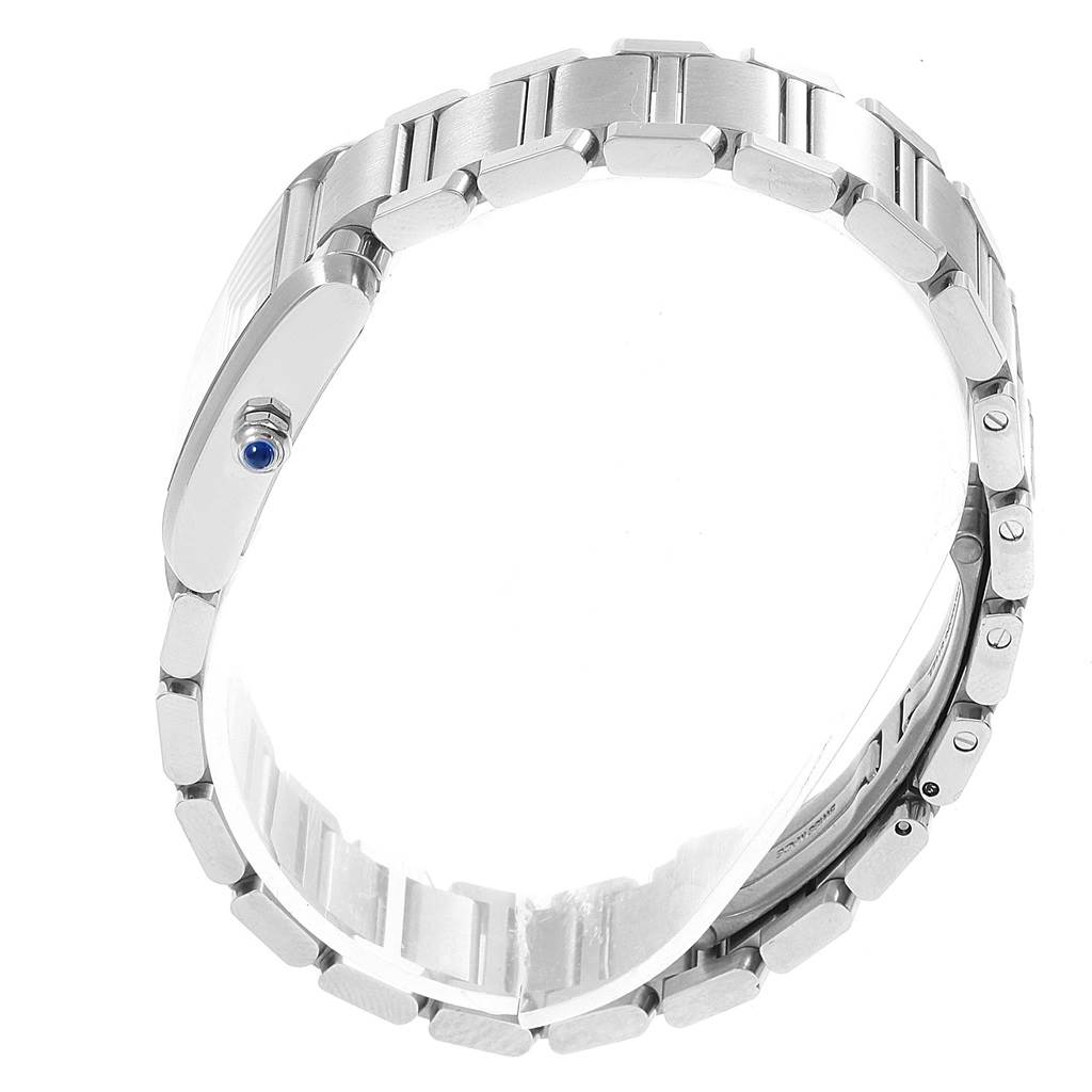 The image shows the side view of a Tank Francaise watch by Cartier, highlighting the bracelet and the crown with a blue gem.