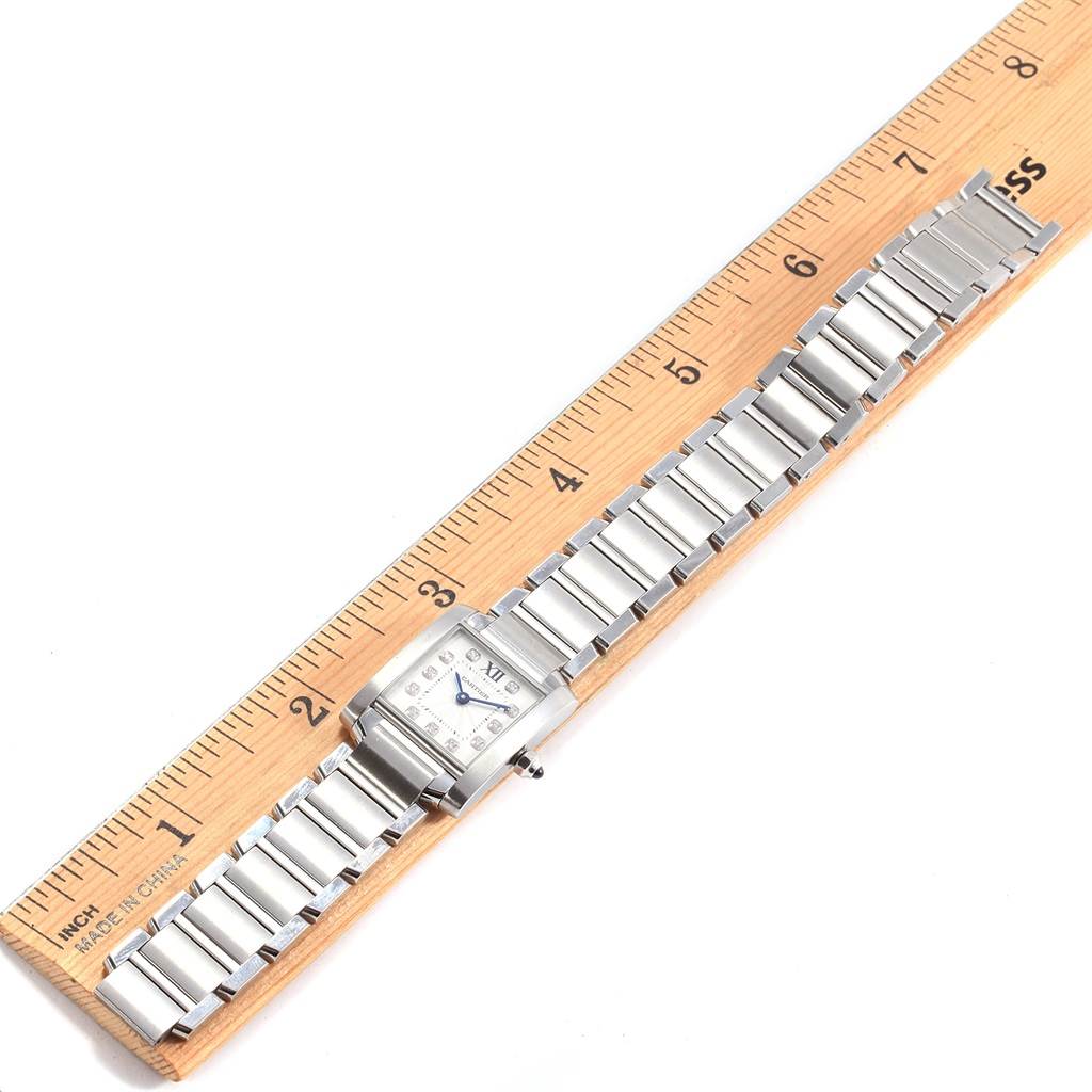 The Cartier Tank Francaise WE110006 Women's Stainless Steel Silver Dial WE110006 Women's Stainless Steel Silver Dial watch is shown from the top angle, displaying the watch face and full metal band along a ruler.