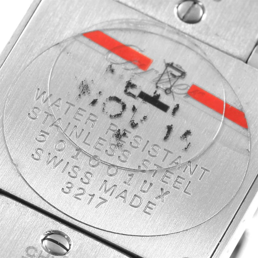 This image shows the engraved stainless steel back of a Cartier Tank Française watch.