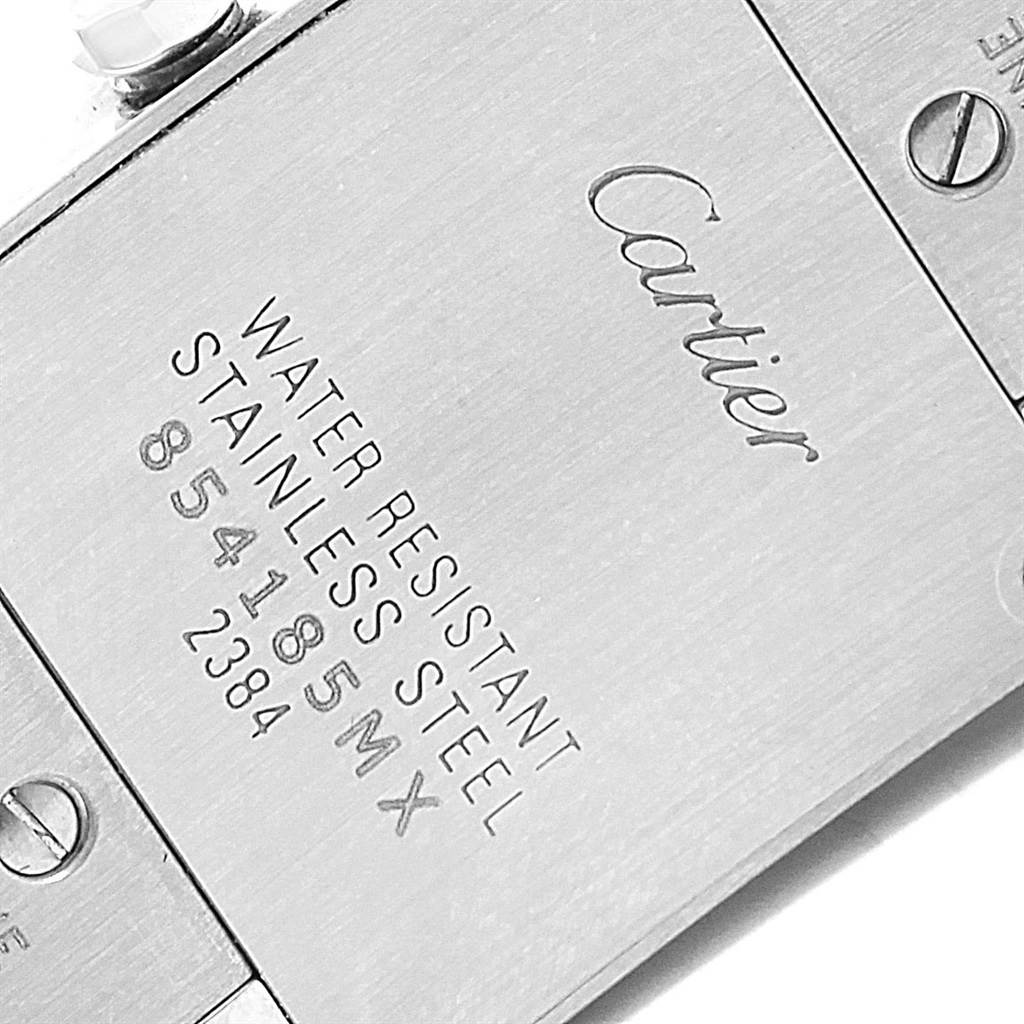 The image shows the back case of a Cartier Tank Francaise W51034Q3 Women's Stainless Steel Mother of Pearl Dial W51034Q3 Women's Stainless Steel Mother of Pearl Dial watch, displaying inscriptions and screws.