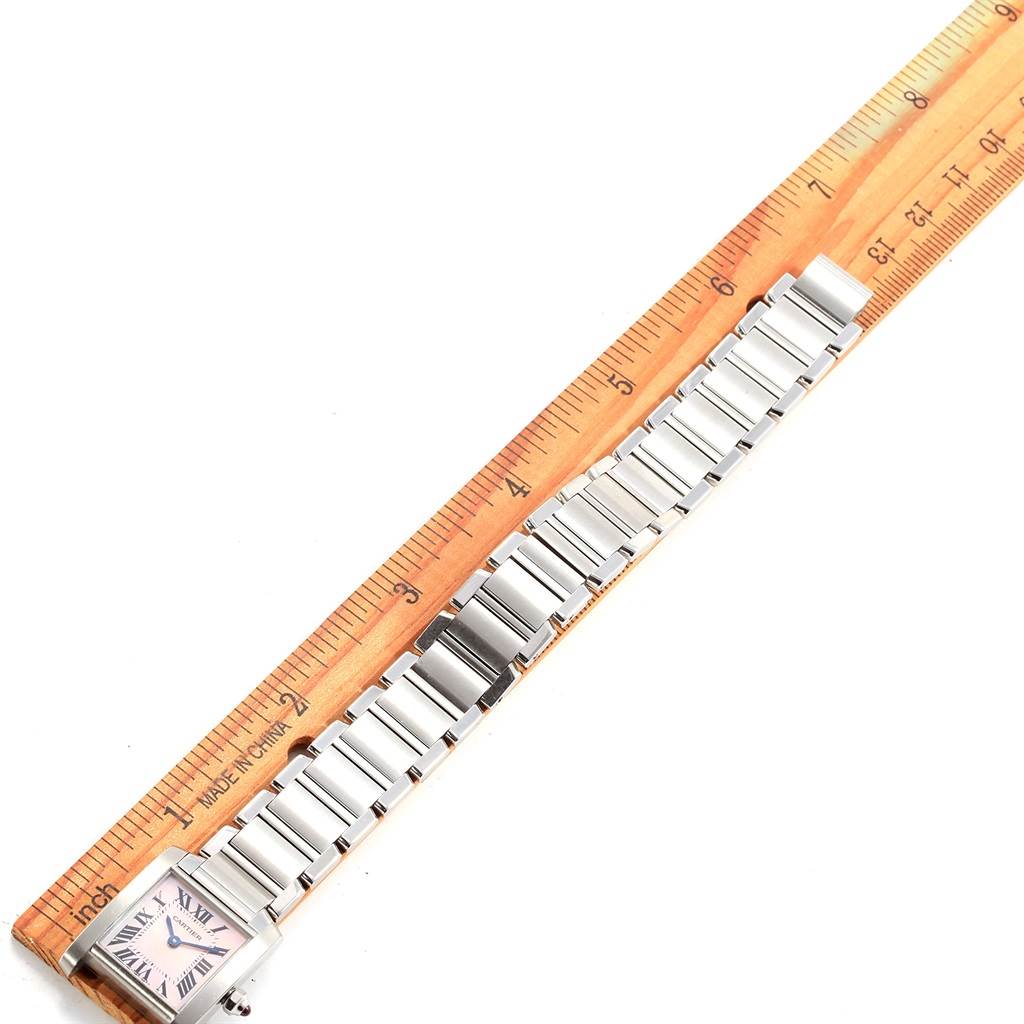 The image shows a top-down view of a Tank Francaise model watch by Cartier, with a ruler measuring the length of its metal bracelet.