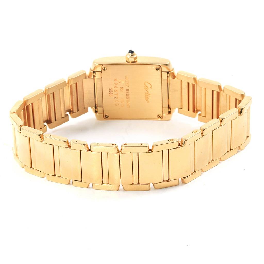 The image shows the back view of a Cartier Tank Francaise W50002N2 Women's Yellow Gold Silver Dial W50002N2 Women's Yellow Gold Silver Dial watch, highlighting its gold bracelet and case back.