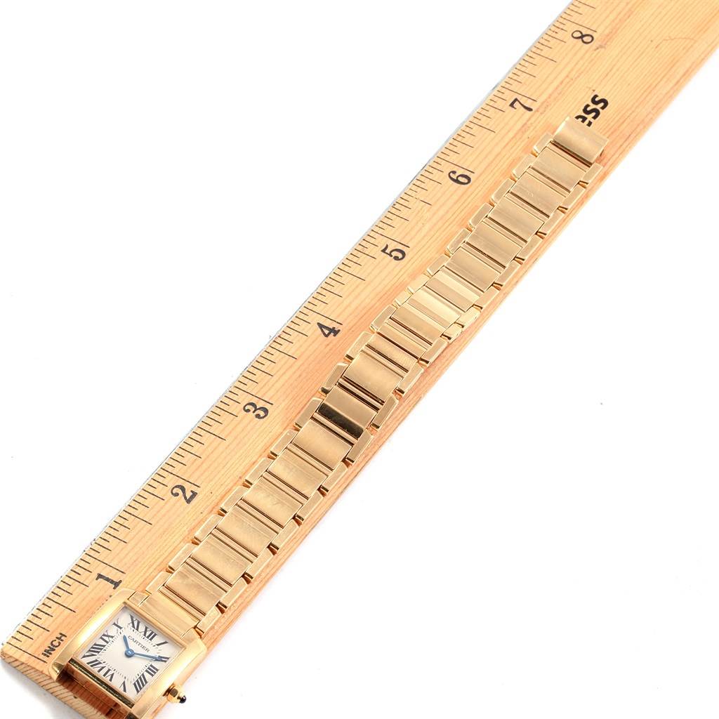 The image shows a Cartier Tank Francaise W50002N2 Women's Yellow Gold Silver Dial W50002N2 Women's Yellow Gold Silver Dial watch laid flat beside a ruler to measure its length.