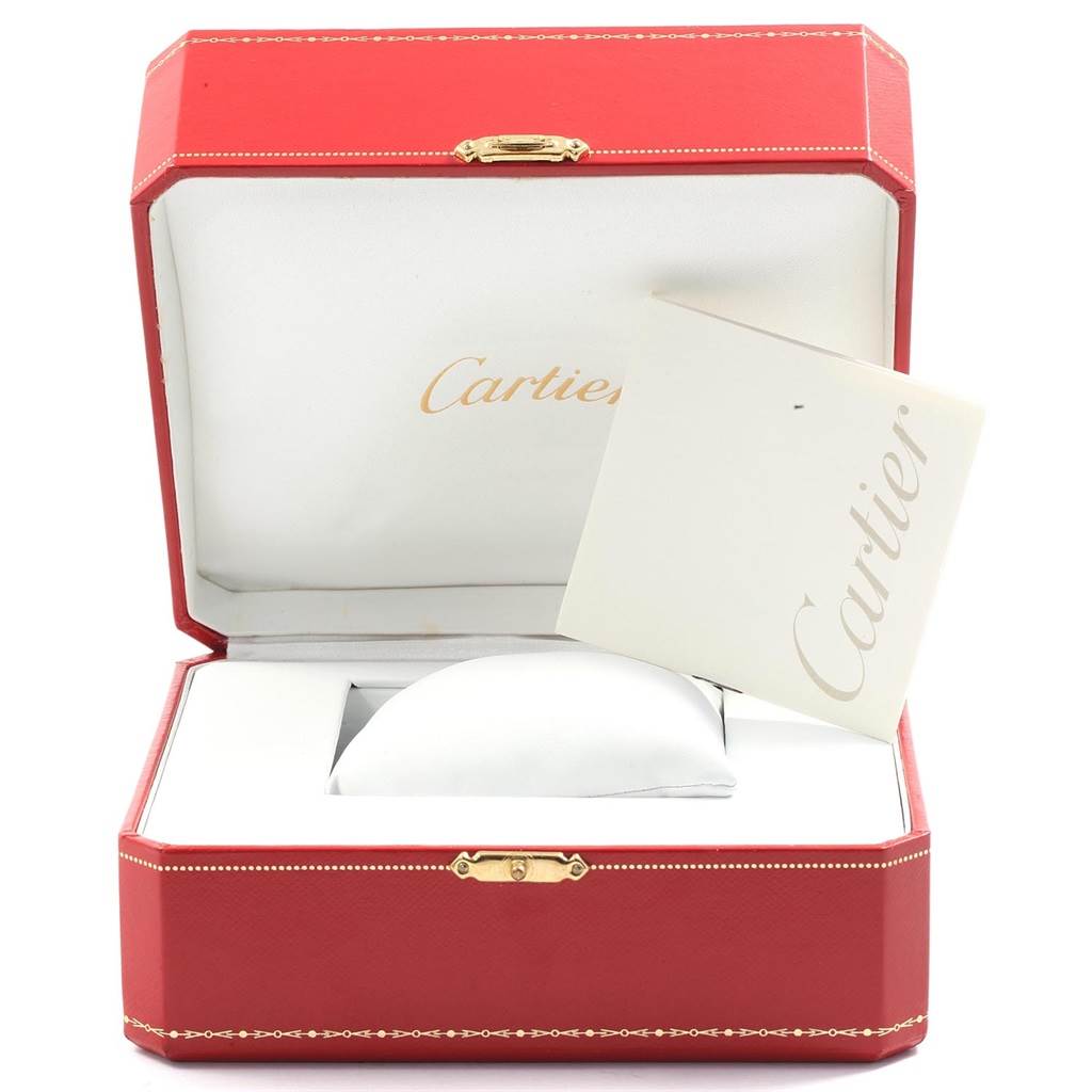 This image shows a Cartier Tank Française watch box with an open lid, displaying its interior cushion and a Cartier booklet.