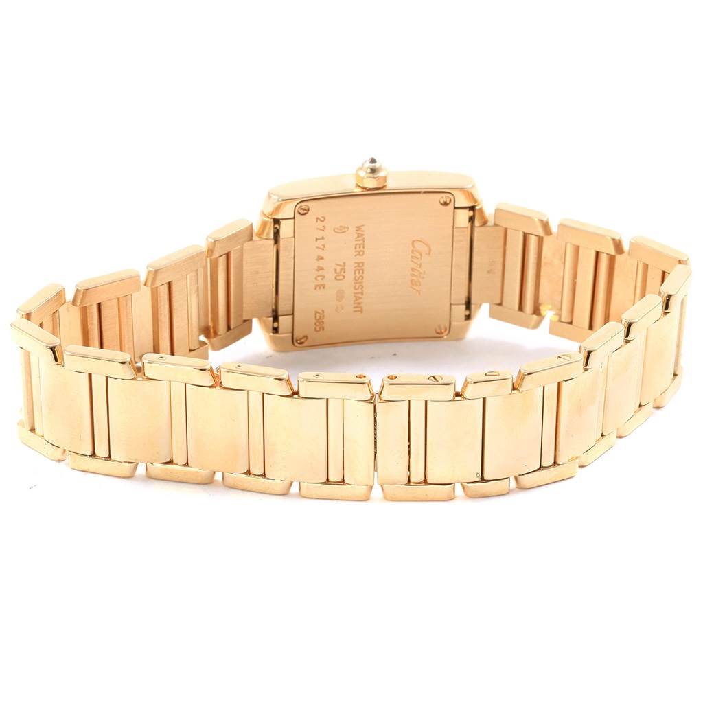 The image shows the backside of a Cartier Tank Francaise WE1001R8 Women's Yellow Gold Silver Dial WE1001R8 Women's Yellow Gold Silver Dial watch, featuring its gold bracelet and case back.