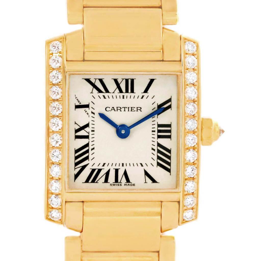 The image shows a Cartier Tank Francaise WE1001R8 Women's Yellow Gold Silver Dial WE1001R8 Women's Yellow Gold Silver Dial watch face at a frontal angle, highlighting the gold case, diamond bezel, and blue hands.