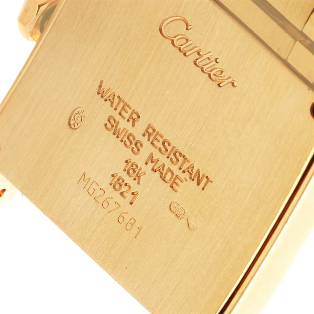 The image shows a close-up of the back case of a Cartier Tank Francaise W50003N2 Women's Yellow Gold Silver Dial W50003N2 Women's Yellow Gold Silver Dial watch, highlighting the brand name, water resistance, and serial number.