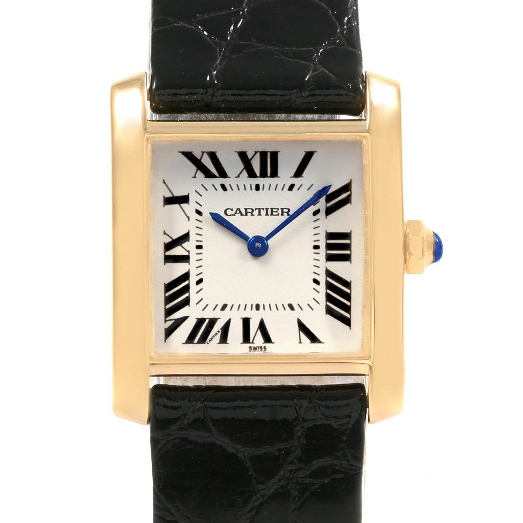 This is a close-up of the Cartier Tank Francaise W50003N2 Women's Yellow Gold Silver Dial W50003N2 Women's Yellow Gold Silver Dial model showing the face, casing, and a portion of the black leather strap.