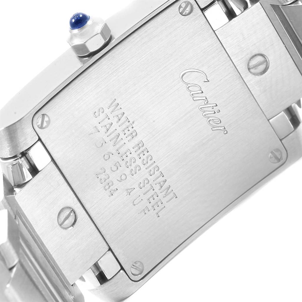 The image shows the back case and part of the bracelet of a Cartier Tank Francaise W51008Q3 Women's Stainless Steel Silver Dial W51008Q3 Women's Stainless Steel Silver Dial watch, focusing on its stainless steel components and engravings.