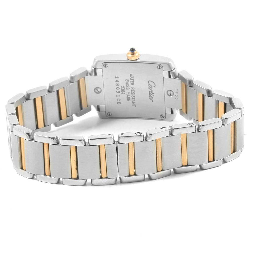 The image shows the back of a Cartier Tank Française watch with its two-tone metal bracelet.