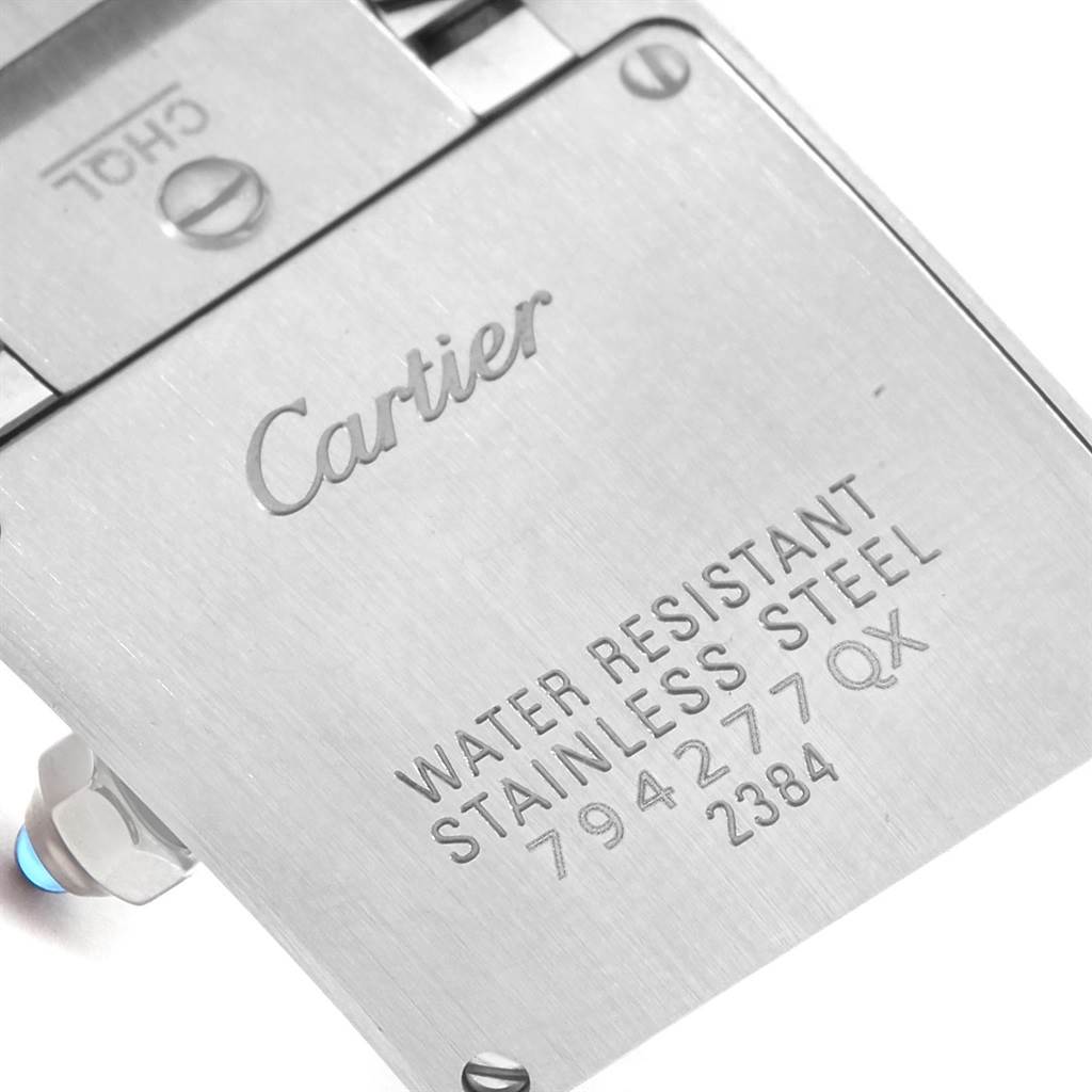 The image shows a close-up of the stainless steel back casing of a Cartier Tank Francaise W51008Q3 Women's Stainless Steel Silver Dial W51008Q3 Women's Stainless Steel Silver Dial watch, showing the engravings.