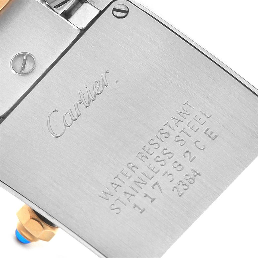 This is a close-up view of the back of a Cartier Tank Française watch, showing the "Cartier" engraving and model specifications.