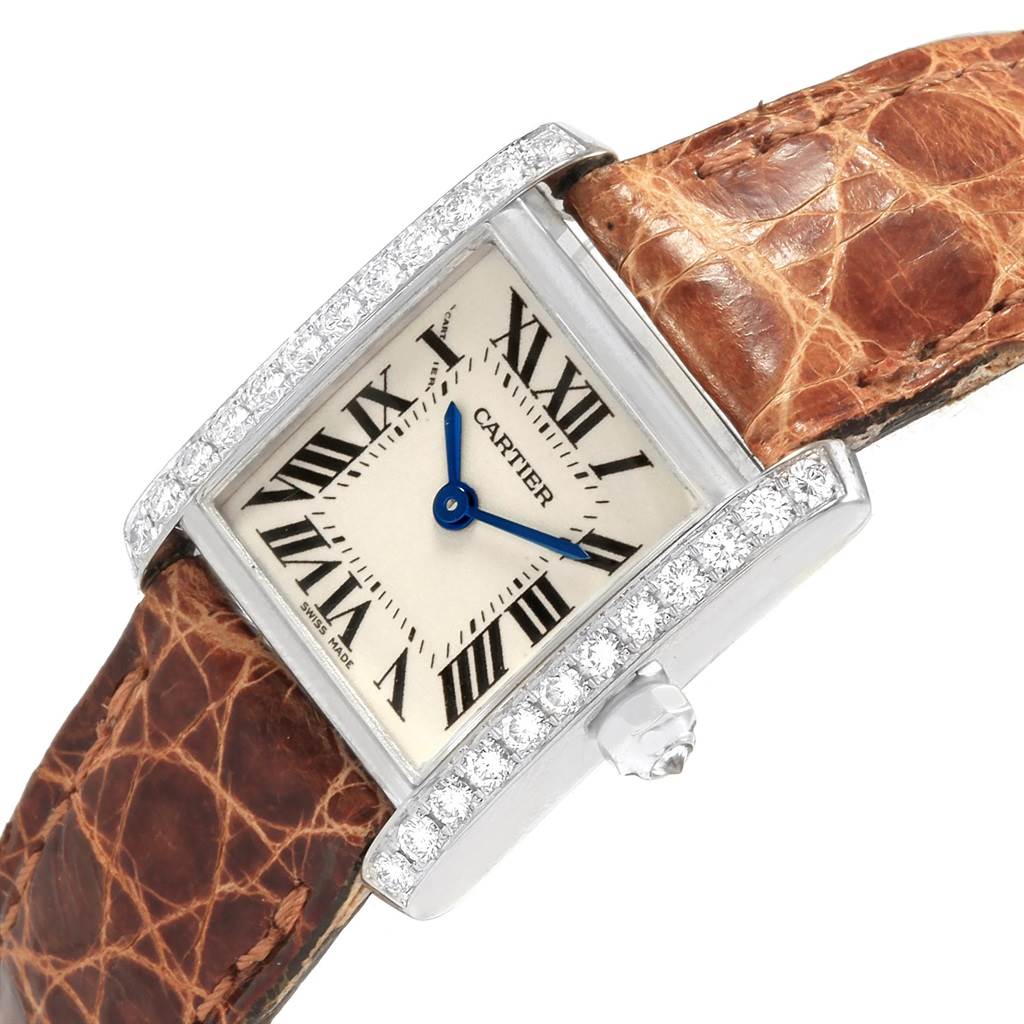 This Cartier Tank Française watch is angled to show its face, diamond-encrusted bezel, and brown leather strap.