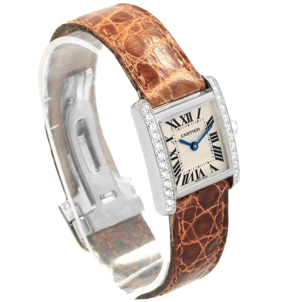 This image shows a frontal angle of a Cartier Tank Francaise WE100231 Women's White Gold Silver Dial WE100231 Women's White Gold Silver Dial watch, featuring its face, diamond-accented bezel, and brown leather strap.